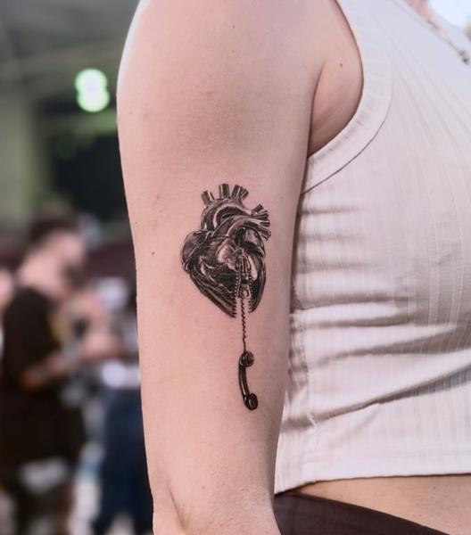 Black and grey realism zipper heart phone tattoo by @dahoonietattoo