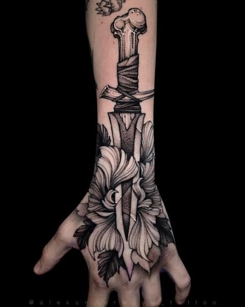 Blackwork dagger and flower tattoo by @alexunderwood_tattoo
