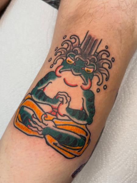 Traditional meditating frog tattoo by @alex.j.griffith