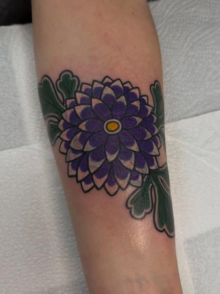 Traditional purple flower tattoo by @alex.j.griffith
