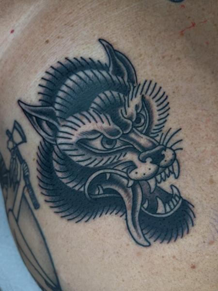 Traditional snarling wolf tattoo by @alex.j.griffith