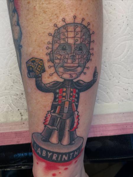 Illustrative pinhead figure tattoo by @alexschwartztattoos