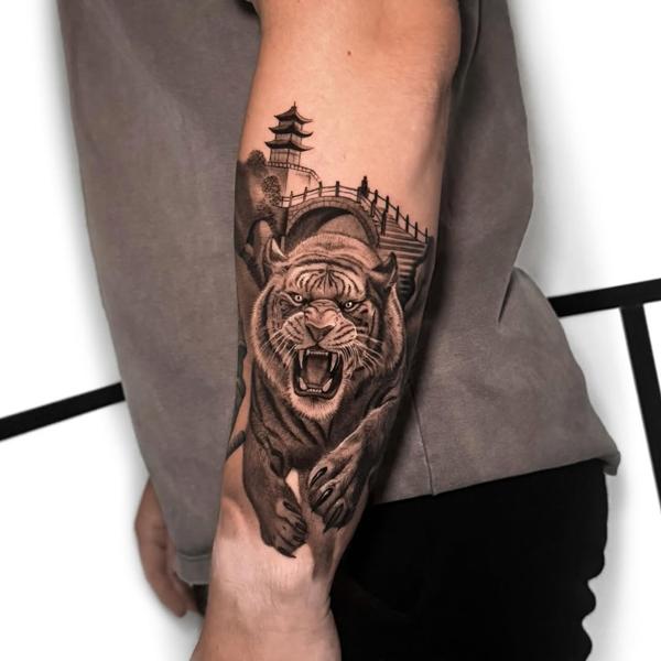 Realism roaring tiger pagoda tattoo by @alfie.wyre.s2