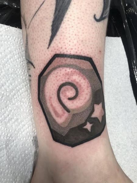 Traditional spiral shell tattoo by @kelpiebat