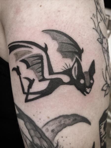 Blackwork flying bat tattoo by @kelpiebat
