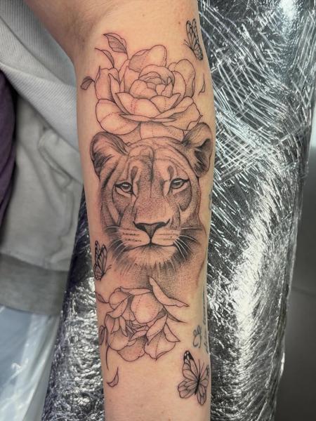 Fine line lion with flowers tattoo by @amberr.tattoos