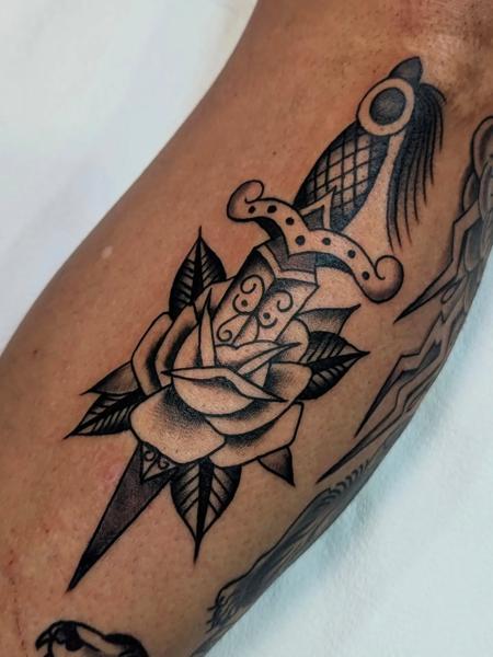 Traditional dagger rose tattoo by @ambermoontattoo