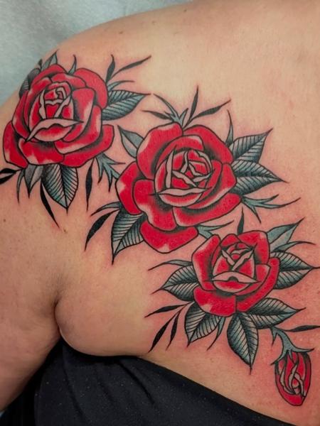 Traditional red roses tattoo by @ambermoontattoo