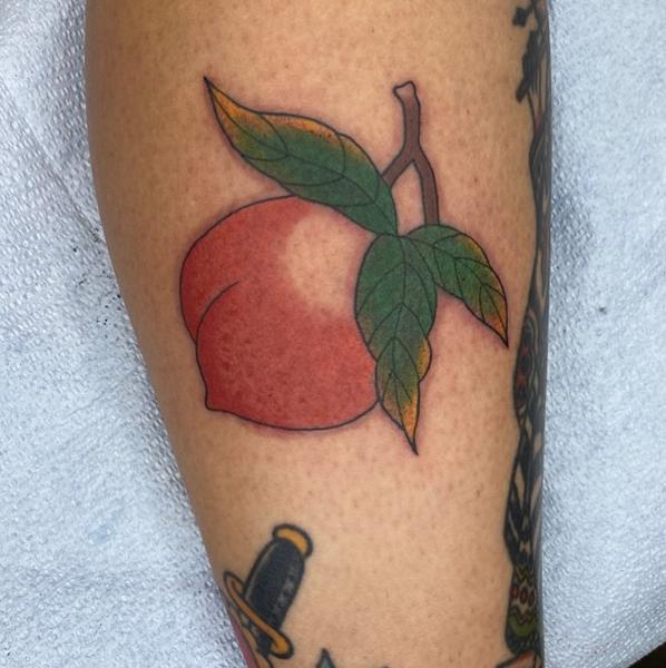 Traditional peach tattoo by @andrewkingtattoo