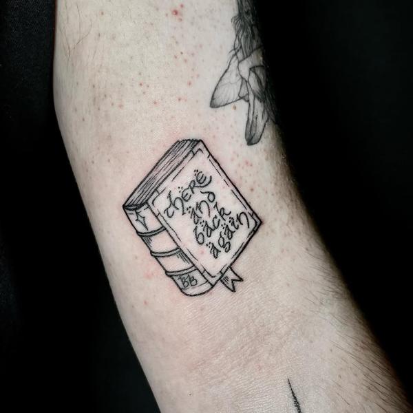 Fine line book with text tattoo by @angie_needs_ink