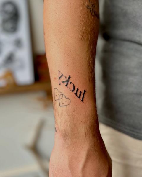 Fine line lucky text tattoo by @fresh.ink.anna