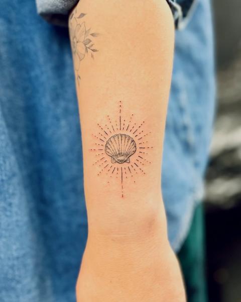 Fine line radiant seashell tattoo by @fresh.ink.anna