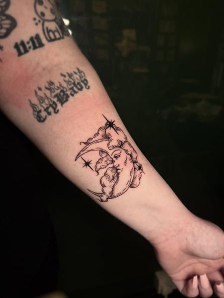 Fine line moon face tattoo by @meerkatstattoo