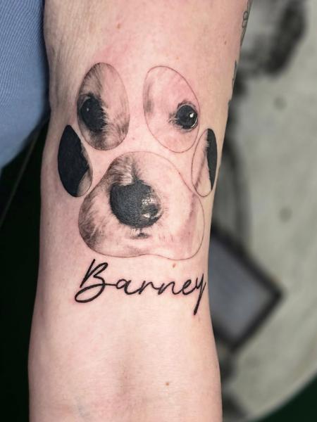 Realism dog paw portrait tattoo by @meerkatstattoo