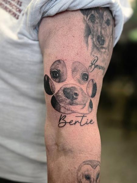 Realism dog paw portrait tattoo by @meerkatstattoo