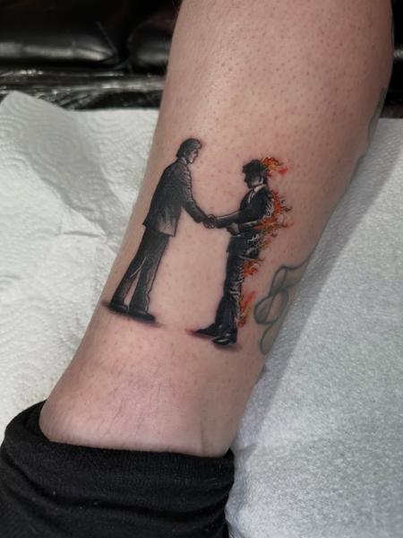 Illustrative burning handshake tattoo by @antclaytattoo