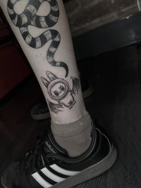 Illustrative sad bunny bat tattoo by @antclaytattoo