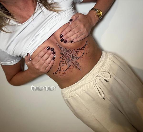 Fine line blackwork ornamental flower tattoo by @wonkyclonky