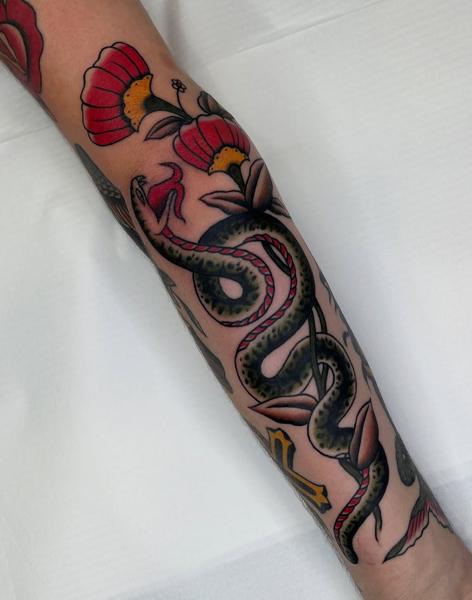Traditional floral snake tattoo by @batter_tattooer
