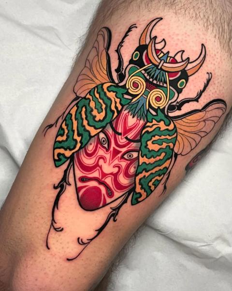 Traditional beetle mask tattoo by @bemuti_tattoos