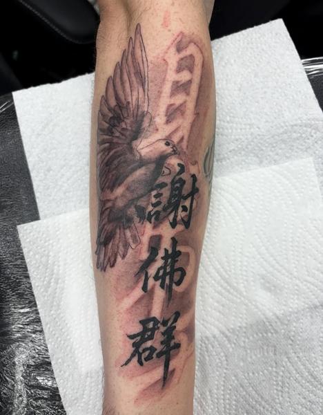 Black and grey dove and kanji tattoo by @skinnysinktattoo