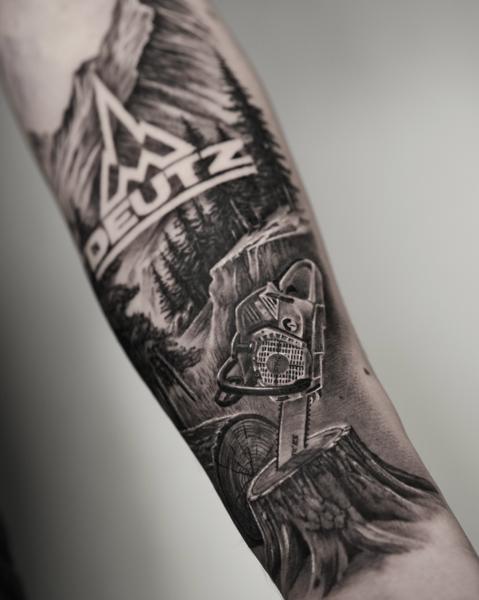 Realism chainsaw landscape tattoo by @black_pen_tattoo