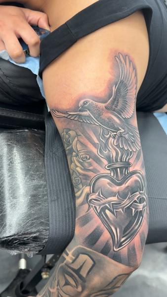 Realism bird and heart tattoo by @bluedevilsink