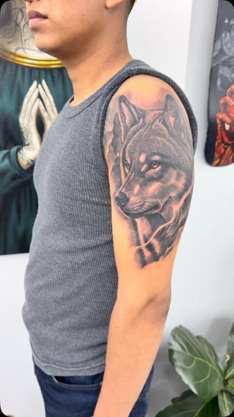 Realism wolf portrait tattoo by @bluedevilsink