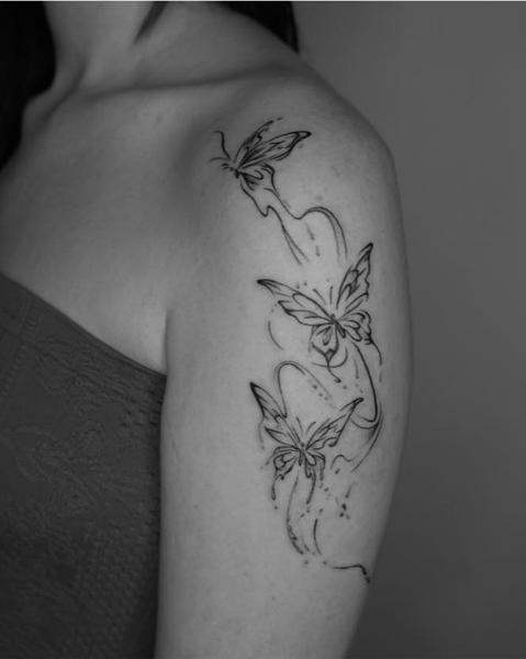 Fine line flying butterflies tattoo by @kwom.tattoos