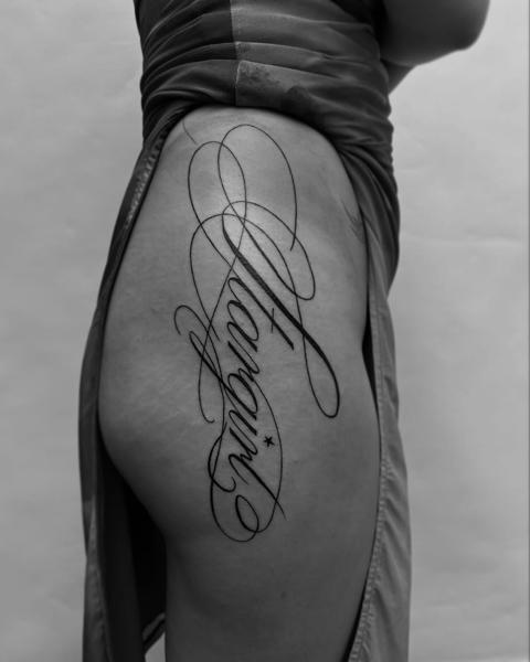 Script script lettering tattoo by @kwom.tattoos