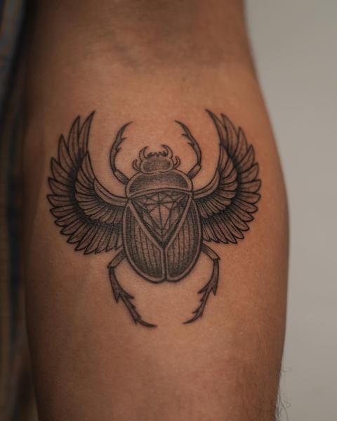 Blackwork winged scarab beetle tattoo by @kwom.tattoos