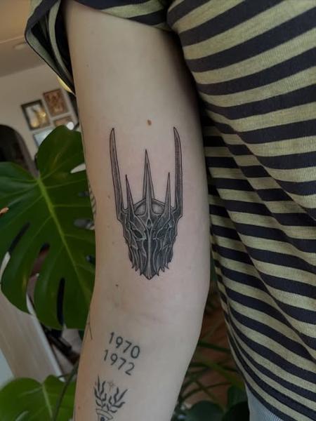 Blackwork spiked helmet tattoo by @dijon.did.it