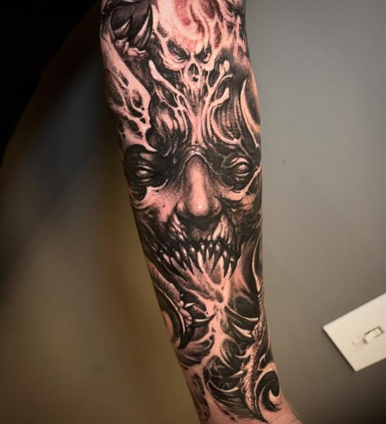Realism demonic face tattoo by @carlgracetattoos