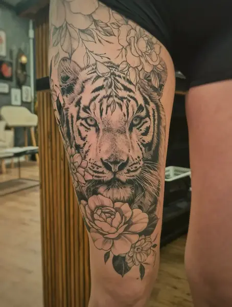 Realism tiger with flowers tattoo by @skibber_tattoo