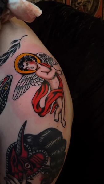 Traditional cherub tattoo by @cedric.weber.tattoo