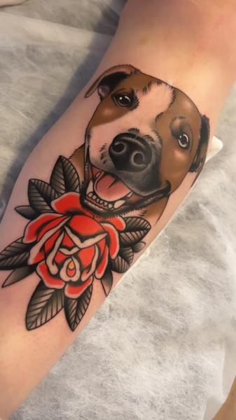 Traditional dog and rose tattoo by @cedric.weber.tattoo