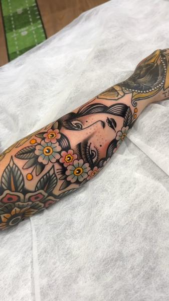 Traditional floral portrait tattoo by @cedric.weber.tattoo