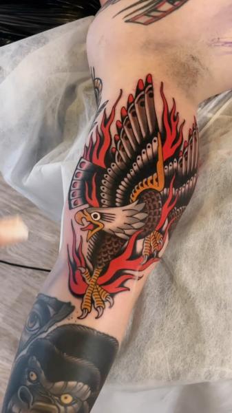 Traditional eagle and flames tattoo by @cedric.weber.tattoo