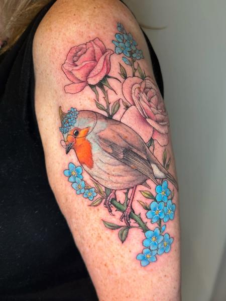 Realism bird and flowers tattoo by @charliesullivantattoo