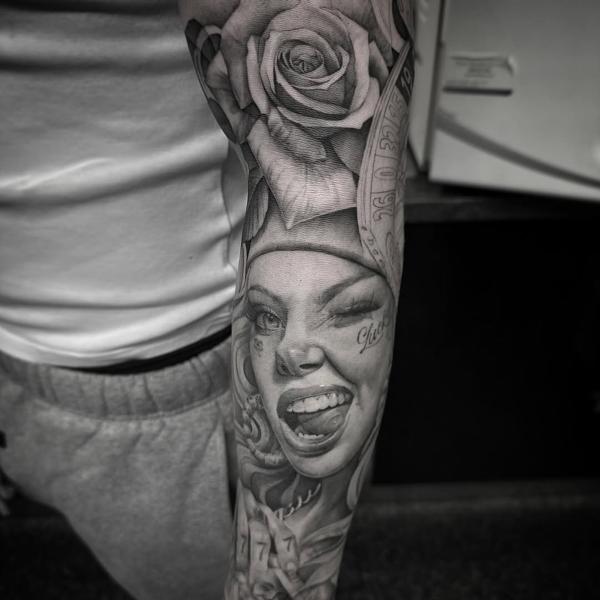 Realism winking woman rose tattoo by @chazappletattoo