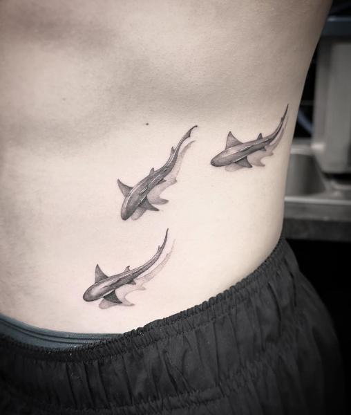 Realism swimming sharks tattoo by @chazappletattoo