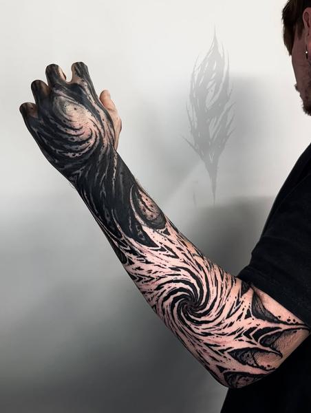 Blackwork abstract vortex tattoo by @charliegatestattoo