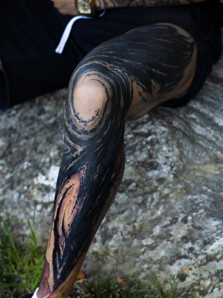 Blackwork abstract swirl tattoo by @charliegatestattoo