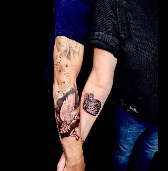 Realism dove and lock tattoo by @chico_payaso.ink