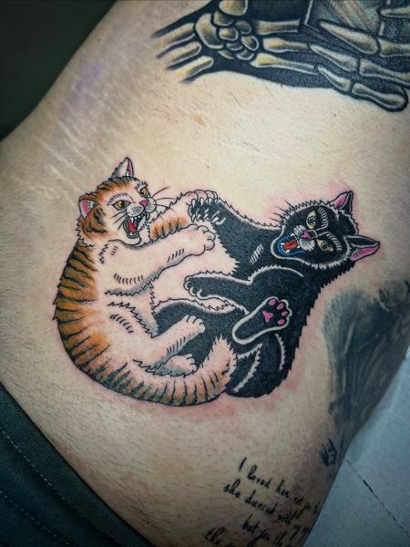 Traditional fighting cats tattoo by @radntrad.tattoos