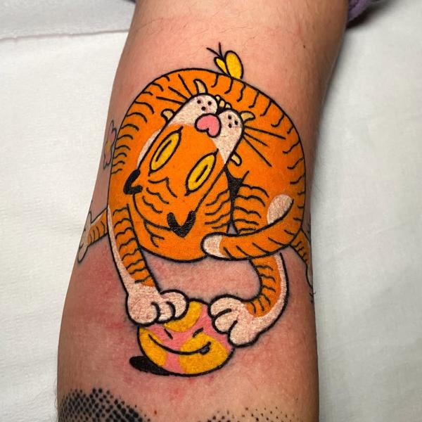 Illustrative cartoon tiger tattoo by @bitros_tattoo
