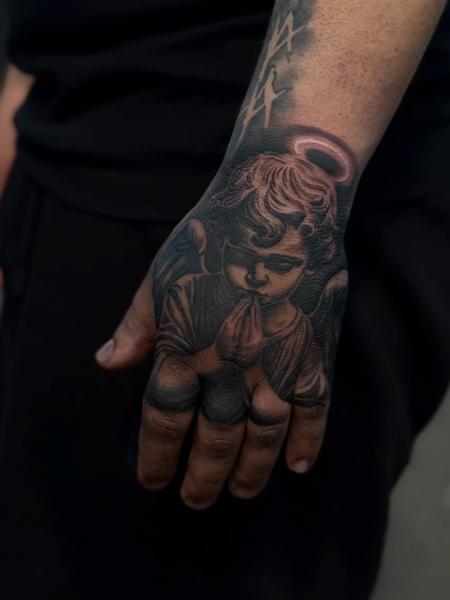 Realism praying angel tattoo by @cnoakestattoo
