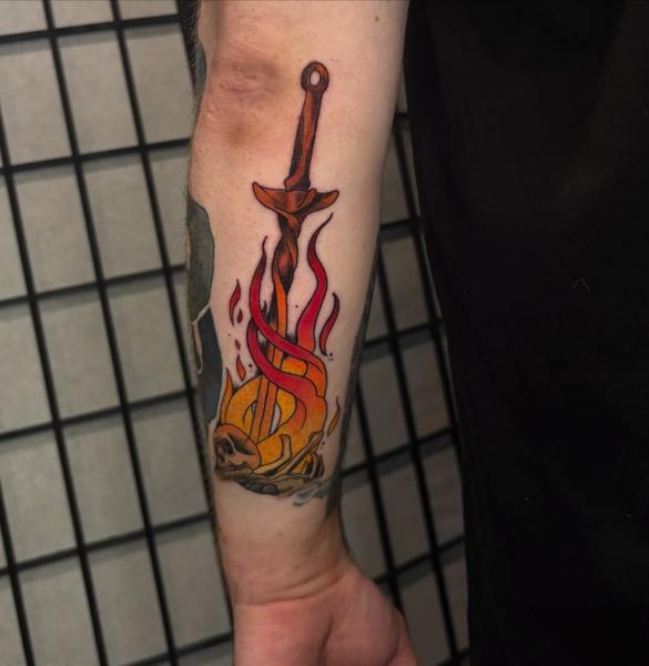 Traditional flaming sword tattoo by @codyeaglestattoo