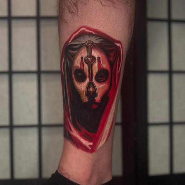 Illustrative masked figure tattoo by @codyeaglestattoo