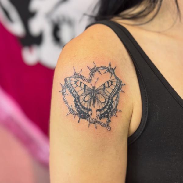 Blackwork barbed wire butterfly tattoo by @courtz_tattoo